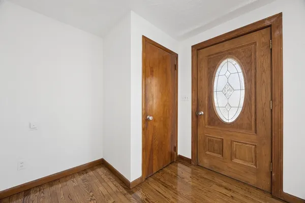 a view of a livingroom with wooden floor and a window