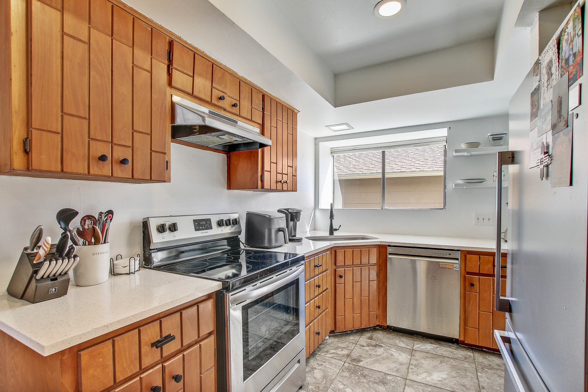 8925 North Plaza, Unit 69 Austin, TX 78753 - Photo 12 of 29 a kitchen with stainless steel appliances granite countertop a sink stove and cabinets