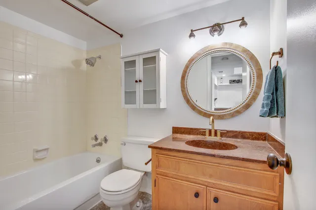 a bathroom with a sink a mirror and a toilet