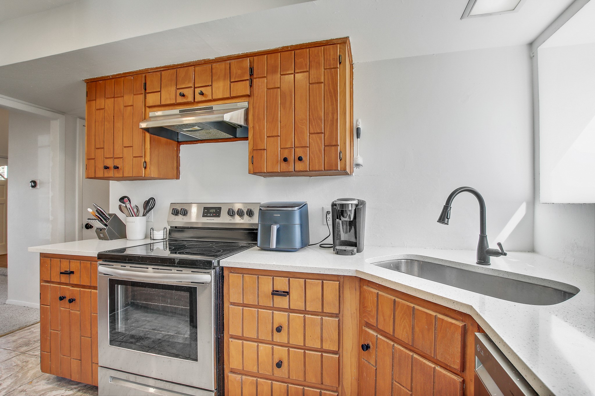 8925 North Plaza, Unit 69 Austin, TX 78753 - Photo 10 of 29 a kitchen with stainless steel appliances granite countertop a stove a sink and a microwave