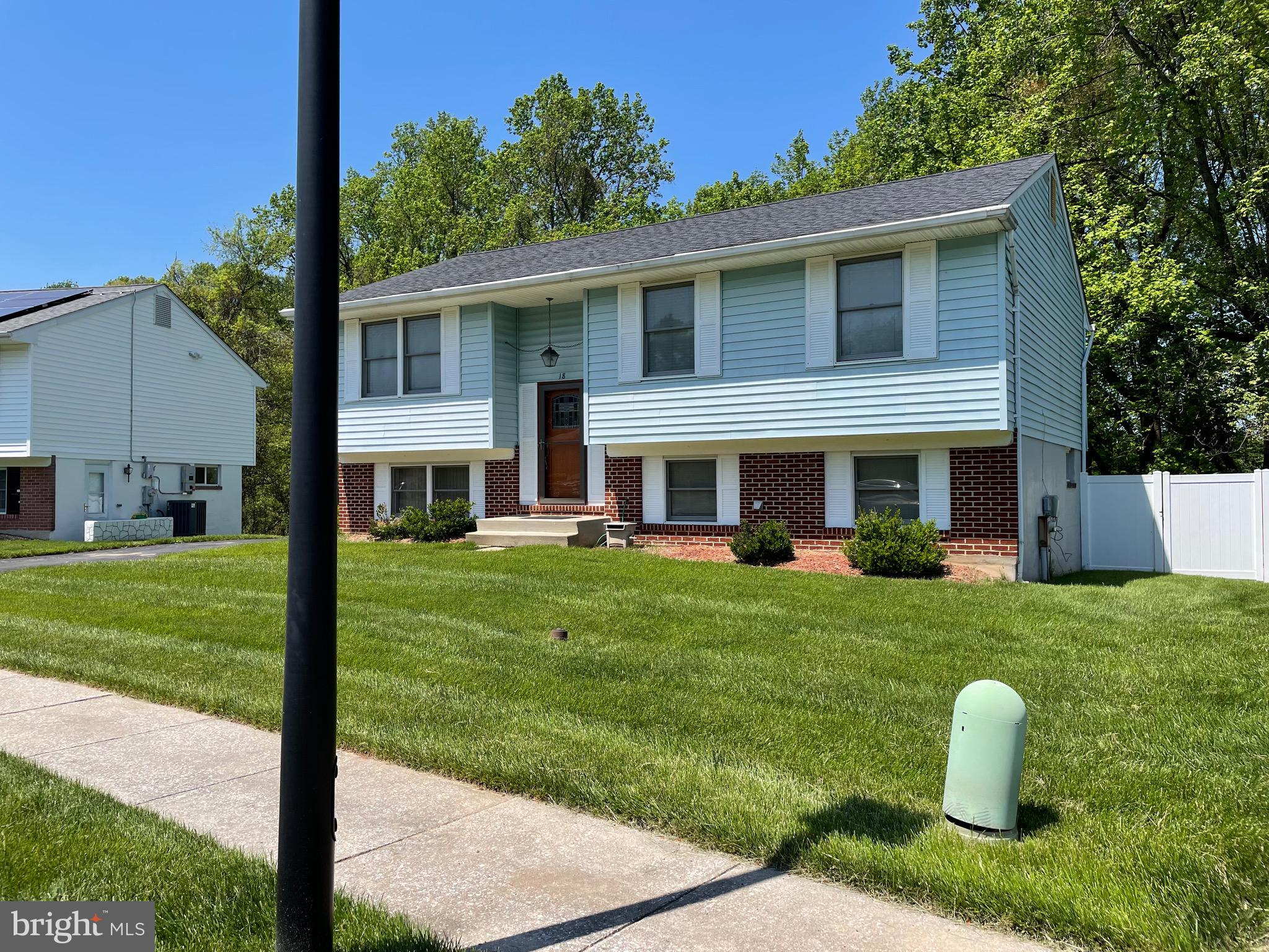 18 Jameson Lane Baltimore, MD 21208 - Photo 2 of 39 a front view of a house with a yard and trees