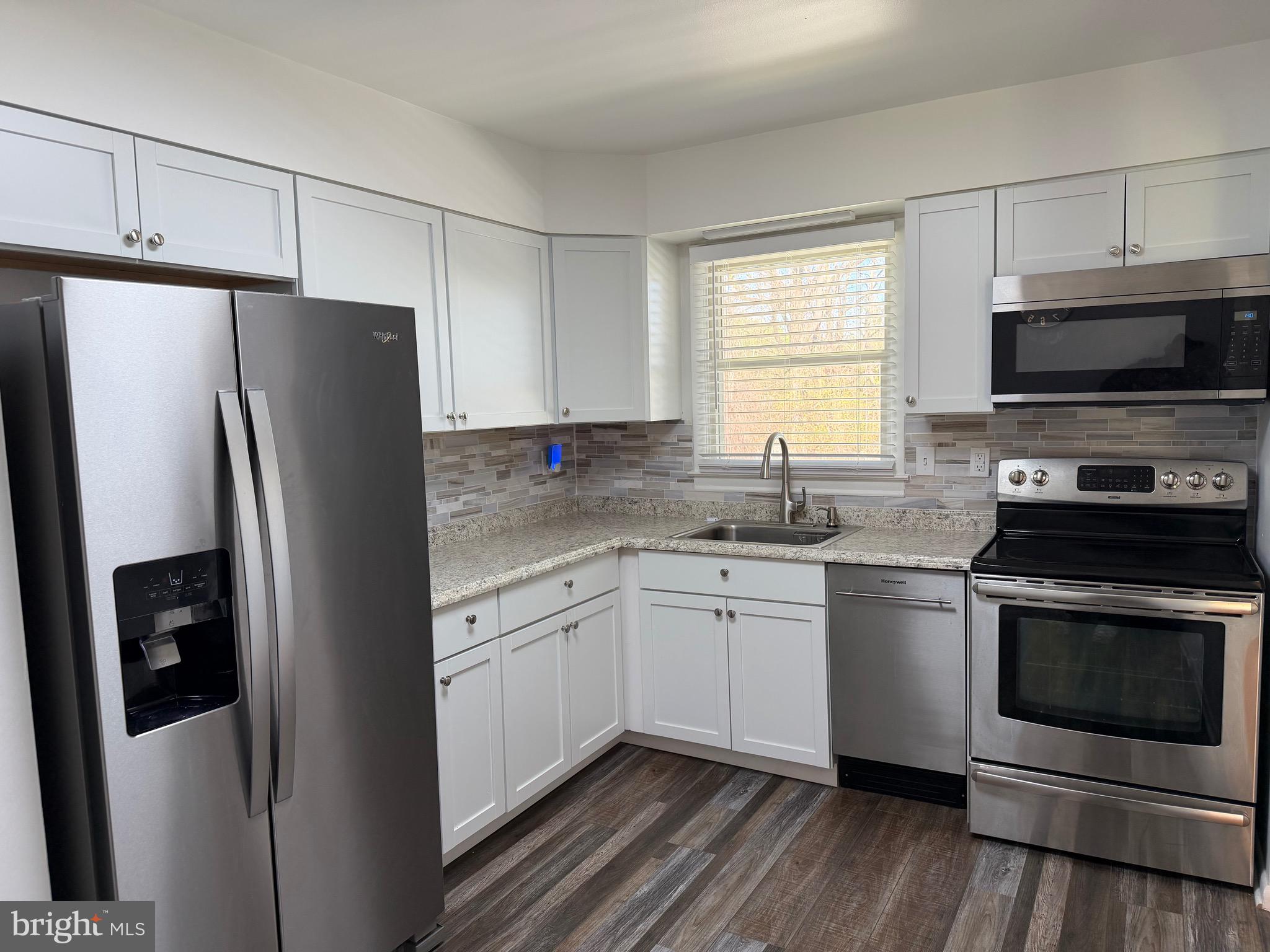 18 Jameson Lane Baltimore, MD 21208 - Photo 10 of 39 a kitchen with stainless steel appliances a refrigerator sink and microwave