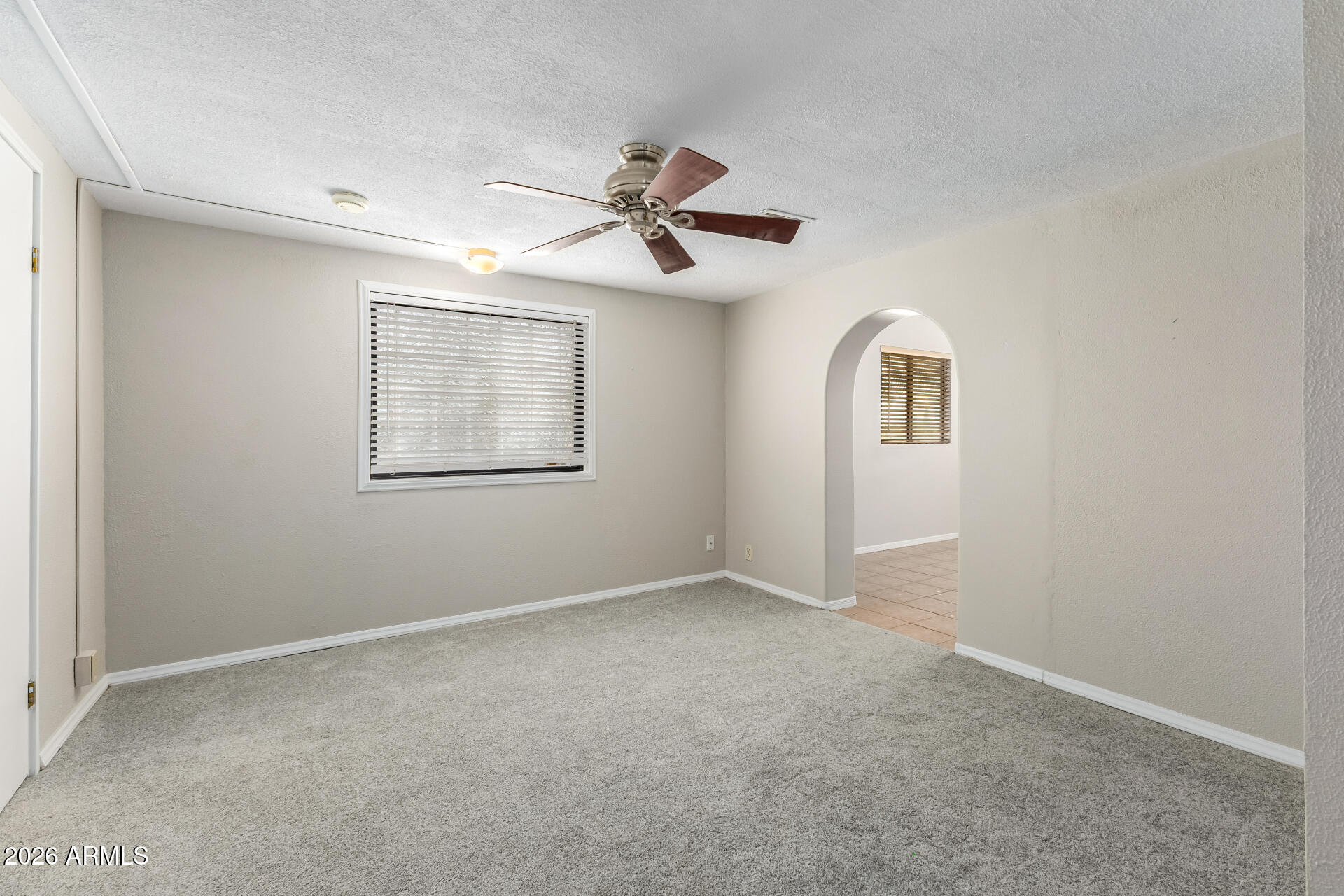 8714 North Dead Mans Gulch Road Florence, AZ 85132 - Photo 12 of 39 an empty room with windows and fan