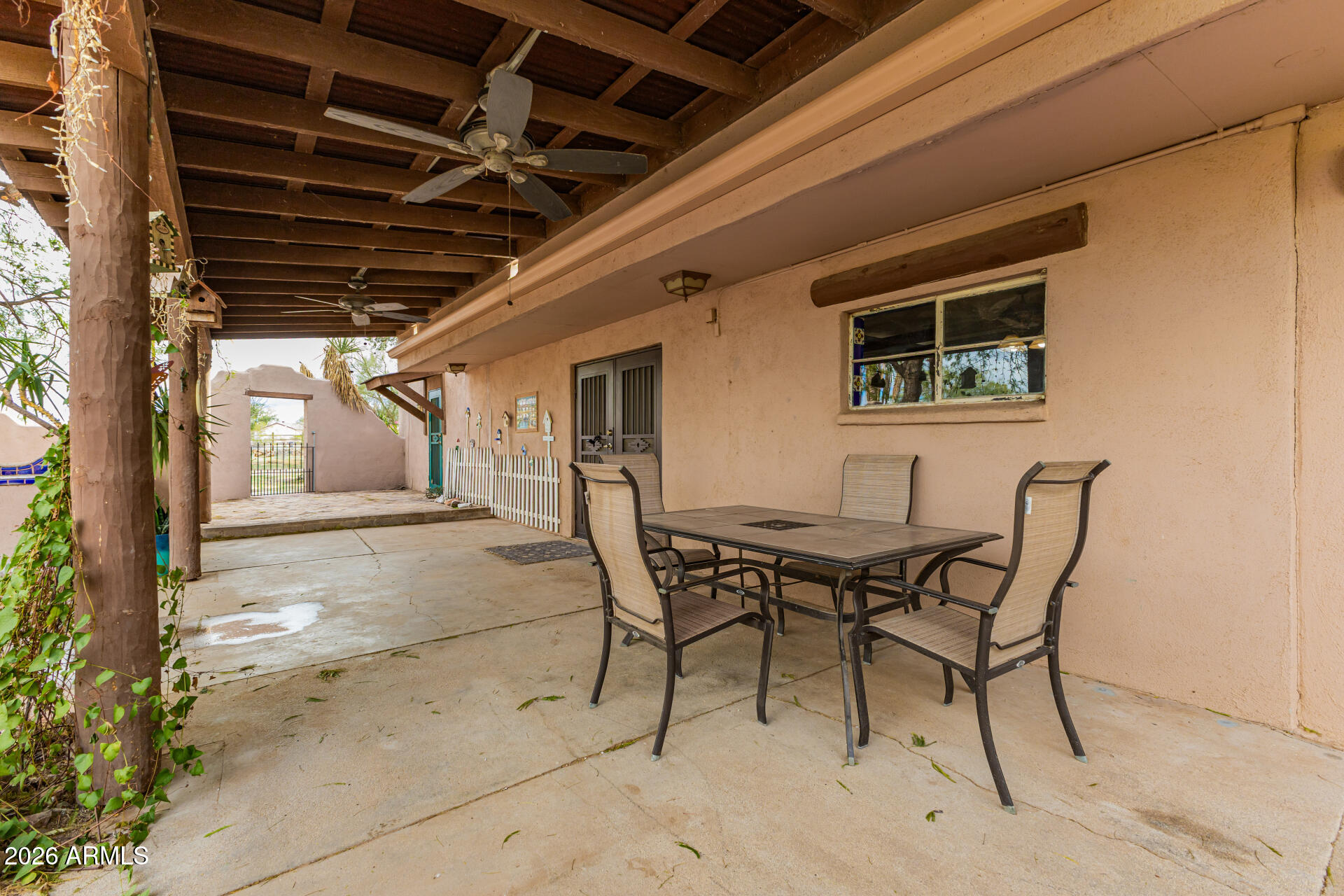 8714 North Dead Mans Gulch Road Florence, AZ 85132 - Photo 19 of 39 a patio with table and chairs with wooden floor and fence