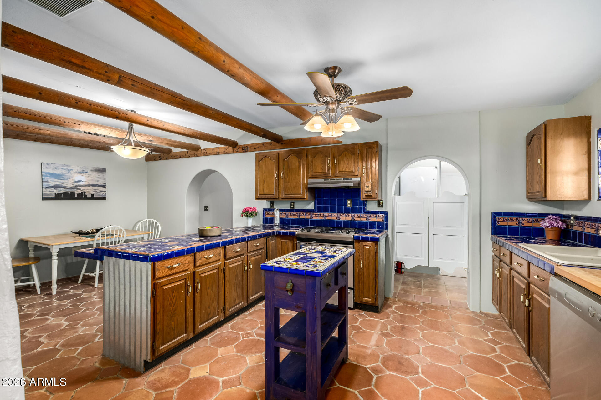 8714 North Dead Mans Gulch Road Florence, AZ 85132 - Photo 8 of 39 a kitchen with stainless steel appliances granite countertop a sink and a stove