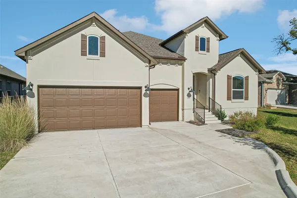 a kitchen with stainless steel appliances kitchen island granite countertop a table chairs sink and cabinets