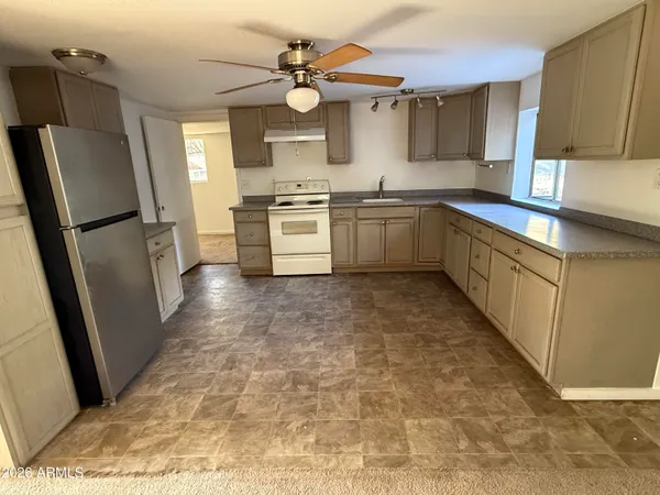 an empty room with windows and cabinet