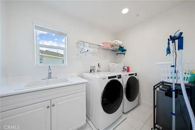 a utility room with sink dryer and washer