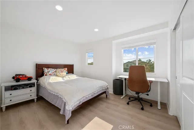 a bedroom with a bed a table and chair