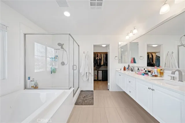 a large space with a large mirror vanity and shower
