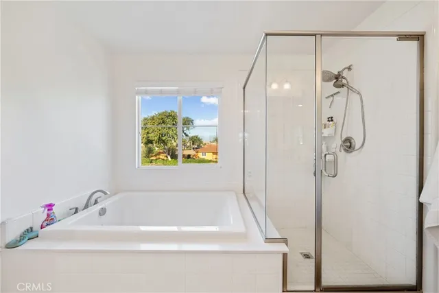 a bathroom with a tub and shower