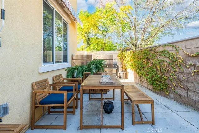 a balcony view with a table and chairs