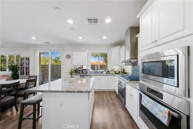 a large kitchen with kitchen island a large window