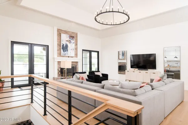 a living room with furniture a flat screen tv and a large window