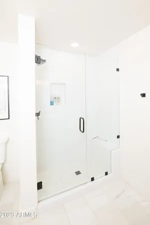 a bedroom with a bed a couch and a window