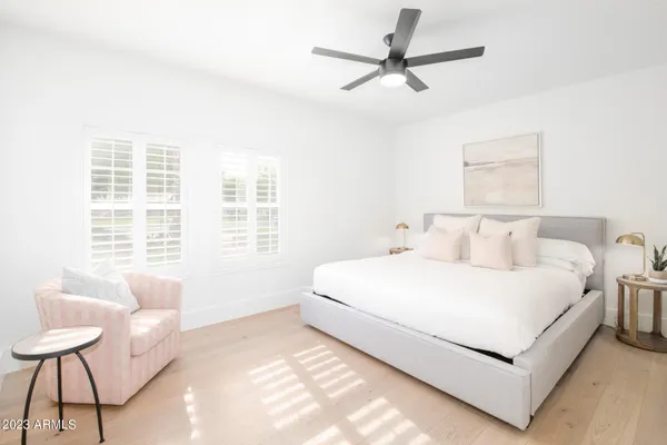 a living room with furniture a flat screen tv and kitchen table