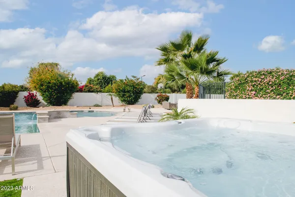 a view of a lake with table and chairs