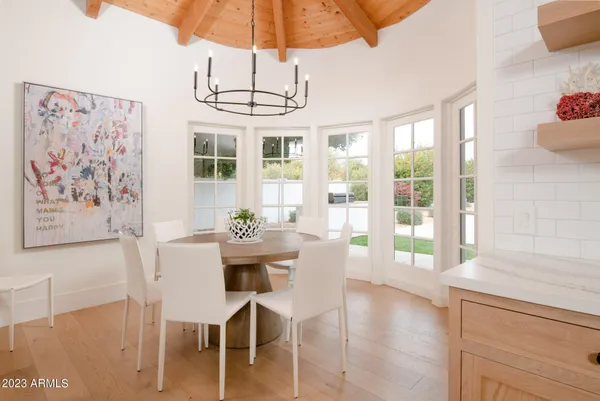a view of a dining room with furniture wooden floor and chandelier