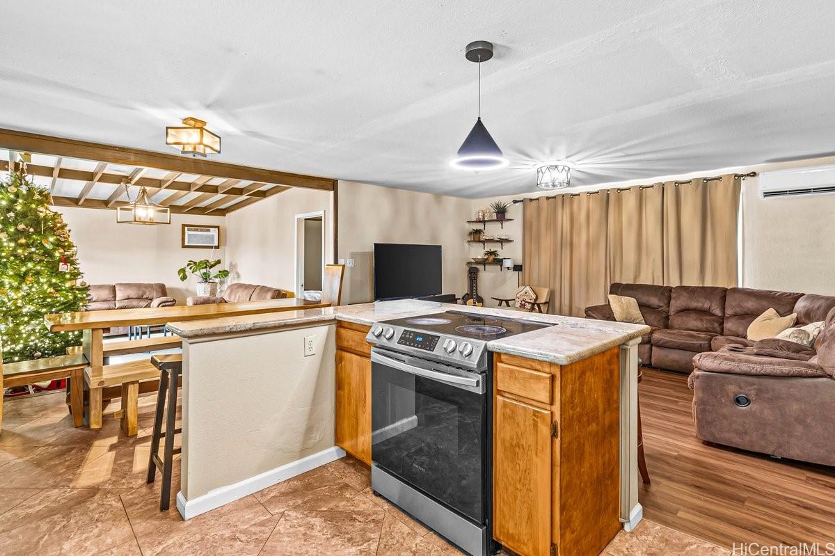 4806 Iiwi Road Kapaa, HI 96746 - Photo 12 of 25 a kitchen with a stove and a sink