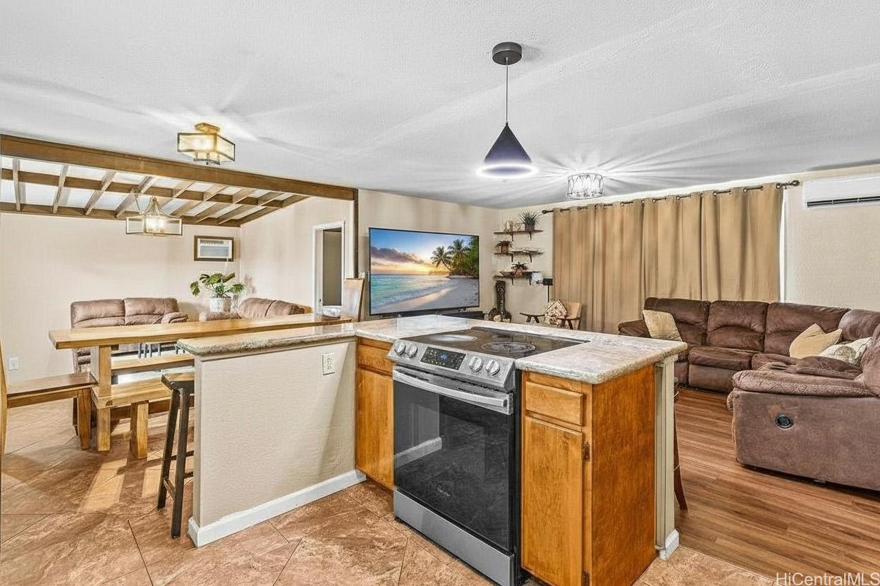 4806 Iiwi Road Kapaa, HI 96746 - Photo 13 of 25 a kitchen with a stove and a sink