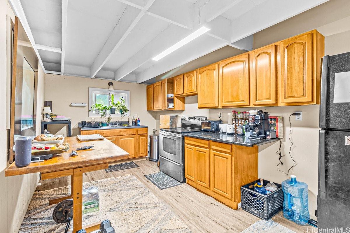 4806 Iiwi Road Kapaa, HI 96746 - Photo 23 of 25 a kitchen with stainless steel appliances kitchen island granite countertop a sink and cabinets