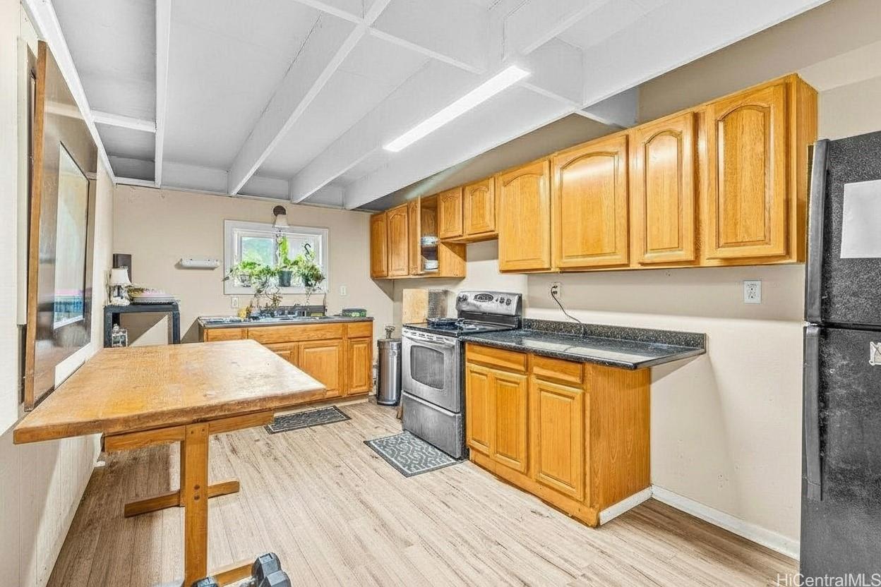 4806 Iiwi Road Kapaa, HI 96746 - Photo 24 of 25 a kitchen with stainless steel appliances granite countertop wooden cabinets a sink and a stove