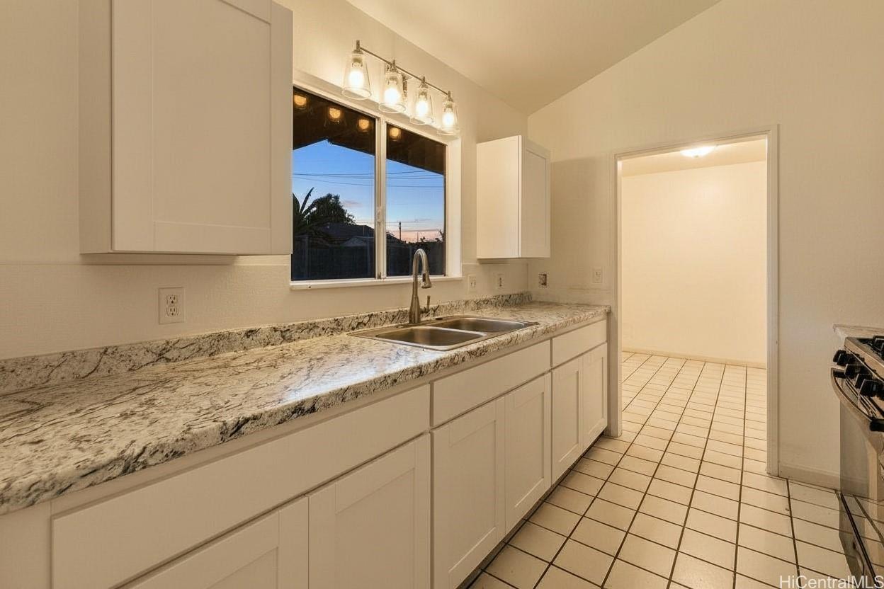 4806 Iiwi Road Kapaa, HI 96746 - Photo 4 of 25 a bathroom with a sink and a mirror