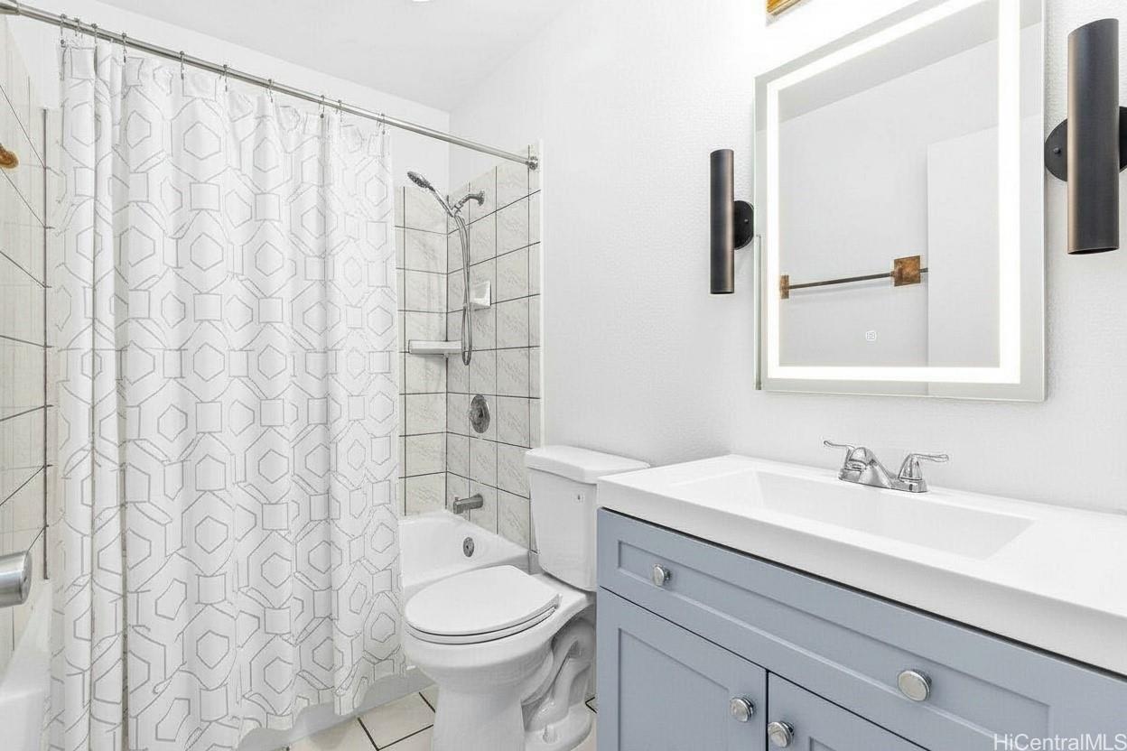 4806 Iiwi Road Kapaa, HI 96746 - Photo 8 of 25 a bathroom with a sink a toilet and shower curtain