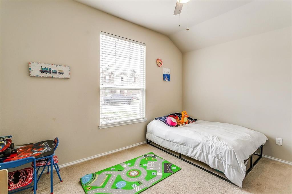 1629 Ridge Creek Lane Aubrey, TX 76227 - Photo 13 of 25 Carpeted bedroom featuring vaulted ceiling and ceiling fan
