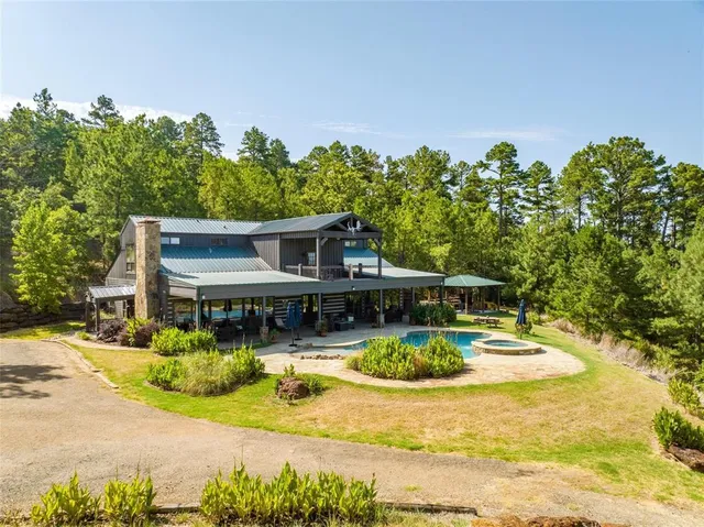 a view of a house with swimming pool and sitting area