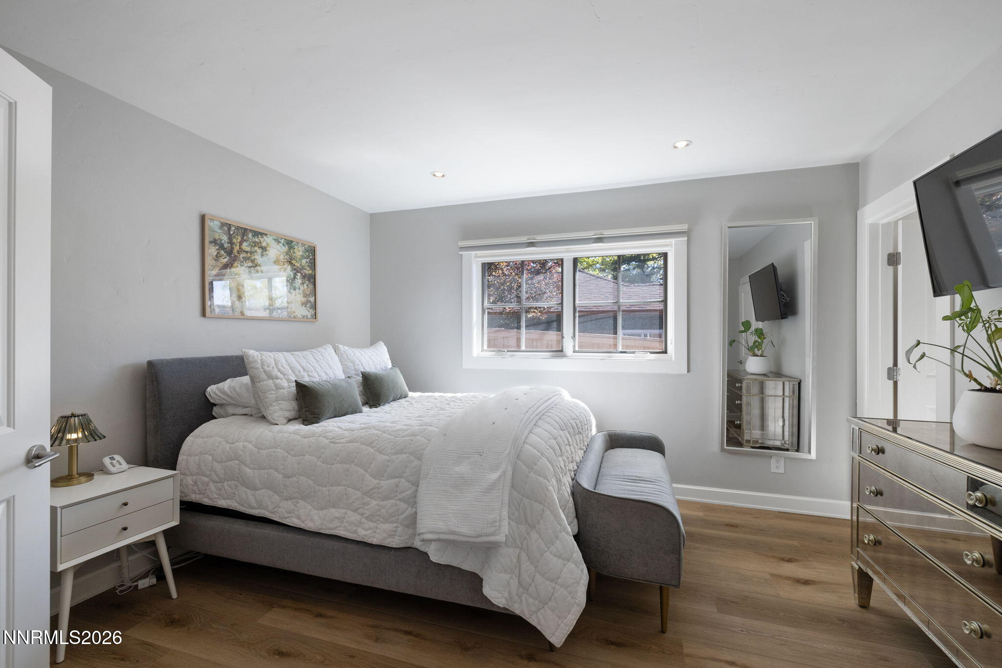 210 Bret Harte Avenue Reno, NV 89509 - Photo 21 of 40 a bedroom with a large bed and a flat tv screen on a dresser