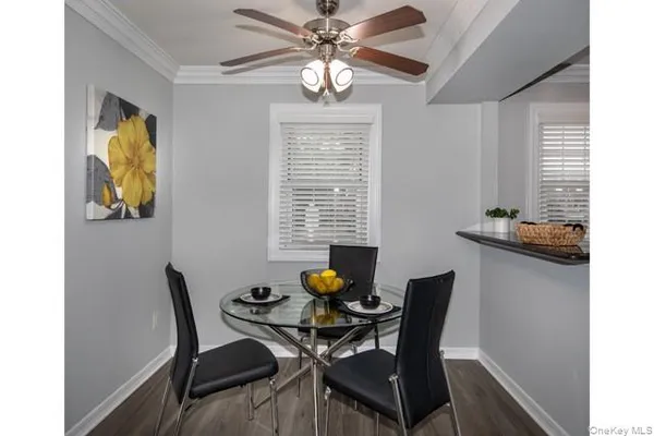 a view of a dining room with furniture and a window