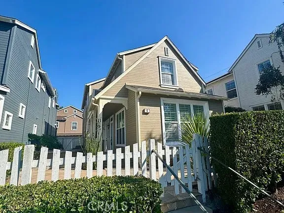 a view of a house with wooden fence