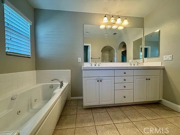 6 Evergreen Road Ladera Ranch, CA 92694 - Photo 18 of 27 a spacious bathroom with a granite countertop sink mirror and bathtub
