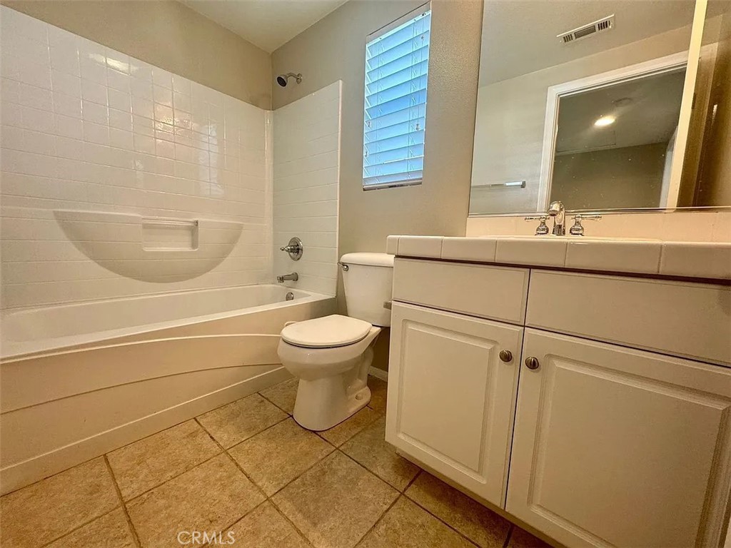 6 Evergreen Road Ladera Ranch, CA 92694 - Photo 22 of 27 a bathroom with a toilet a sink and mirror