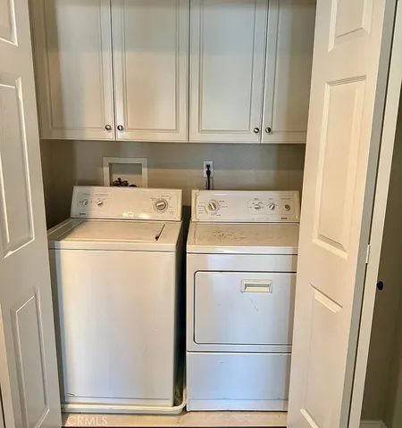a view of storage and utility room with washer and dryer