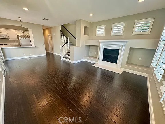 6 Evergreen Road Ladera Ranch, CA 92694 - Photo 5 of 27 a view of a livingroom with wooden floor a fireplace and window