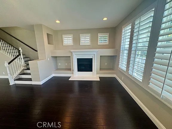 6 Evergreen Road Ladera Ranch, CA 92694 - Photo 7 of 27 a view of an empty room with wooden floor fireplace and a window