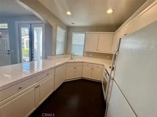 a utility room with cabinets washer and dryer