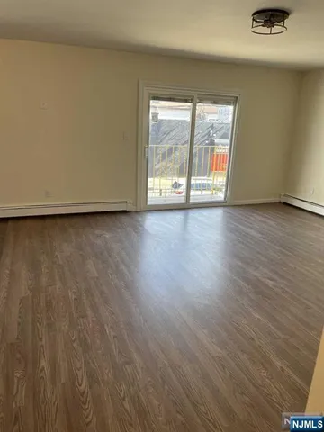 a view of a room with wooden floor and window