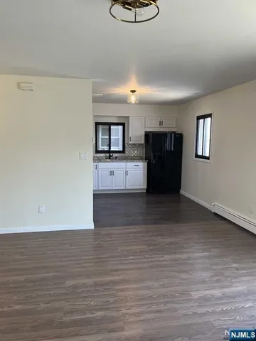 a view of a living room with furniture and a ceiling fan