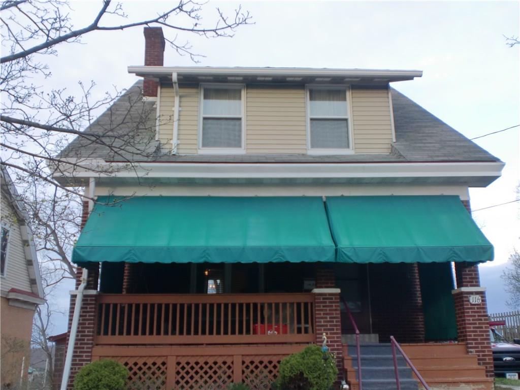 Canvas awnings extend to keep the front porch shaded and private