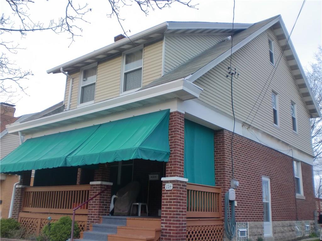 Side view of the home, door opens to basement steps
