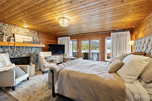 a large bedroom with a bed and a fireplace