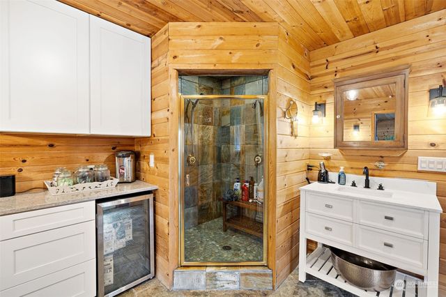 a bathroom with a sink a mirror and a shower