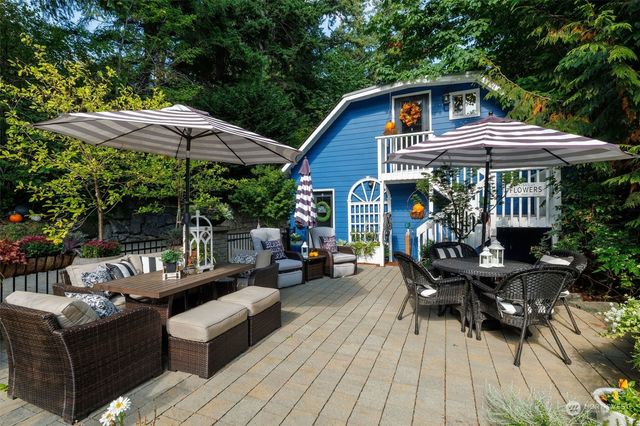a kitchen that has a lot of cabinets a sink and a wooden floor