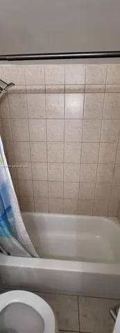 a bathroom with a bathtub and shower