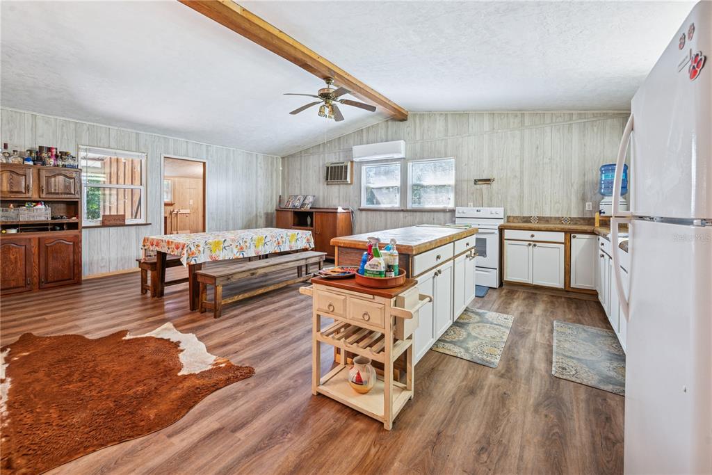 6550 Southwest 100 Court Cedar Key, FL 32625 - Photo 14 of 41 a large white kitchen with sink stove and refrigerator