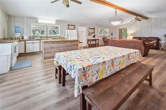 a large bedroom with wooden floor and chandelier