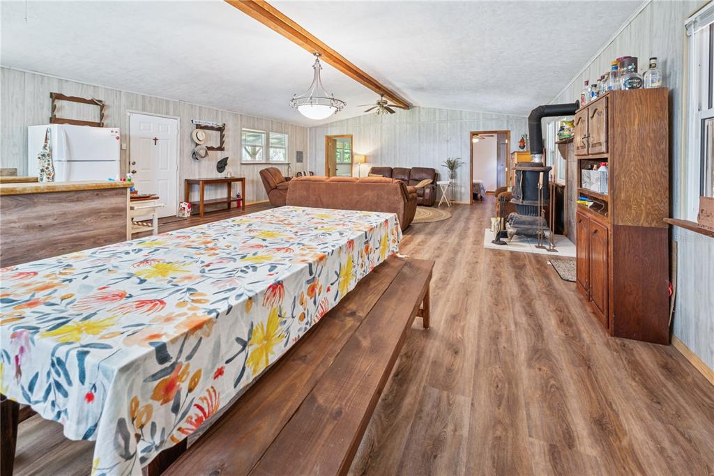 6550 Southwest 100 Court Cedar Key, FL 32625 - Photo 17 of 41 a large bedroom with a bed and wooden floor